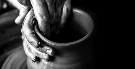 Hands of potter making clay pot