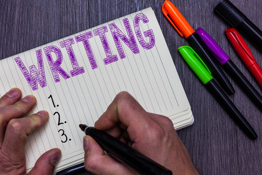 Text sign showing Writing. Conceptual photo Action of write something Making important notes letters papers Man holding marker notebook paper communicating ideas Wooden background