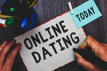 Conceptual hand writing showing Online Dating. Business photo text Searching Matching Relationships eDating Video Chatting Man holding marker paper clothespin reminder cup marker wood table