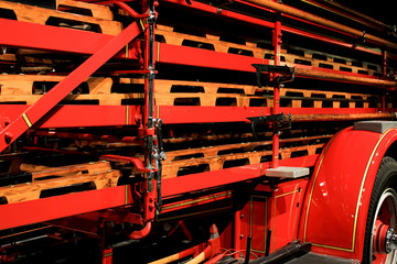 Fototapeta premium stack of wood ladders on vintage fire truck