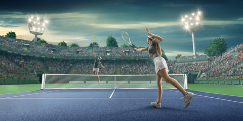 Female athlete plays tennis on a professional court - obrazy, fototapety, plakaty