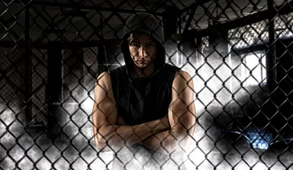 Foto op Aluminium Strong mixed martial arts fighter inside the cage © Andrey Burmakin