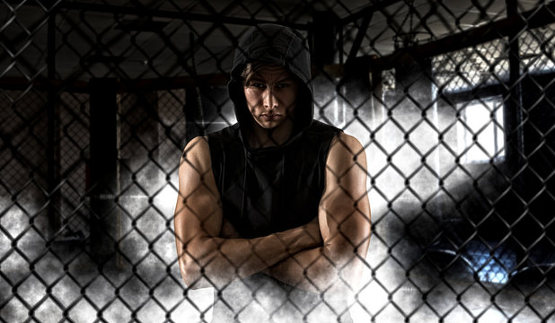 Strong mixed martial arts fighter inside the cage