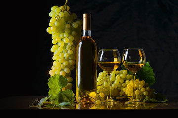 The composition of bottle 2 glass of white wine and fresh grapes