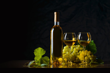 Fototapeta premium The composition of bottle 2 glass of white wine and fresh grapes