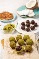 Chocolate praline balls placed in marzipan shell.; Step of cooking marzipan raw-vegan candies. Healthy eating concept.