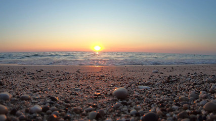 Obraz premium Sunset on the blue sea beach