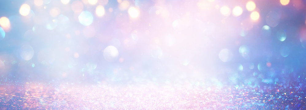 blackground of abstract glitter lights. blue, pink, gold and silver. de focused