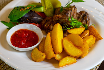 Grilled meat (kebab) with vegetables and sauce