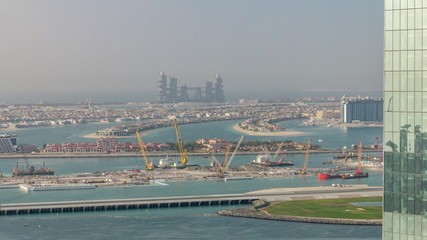 Aerial view of Palm Jumeirah man made island from JBR district before sunset timelapse. Dubai, UAE.