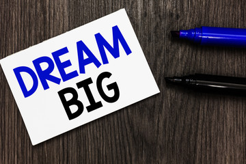 Text sign showing Dream Big. Conceptual photo To think of something high value that you want to achieve Important idea ideas notebook marker markers wooden background reminder