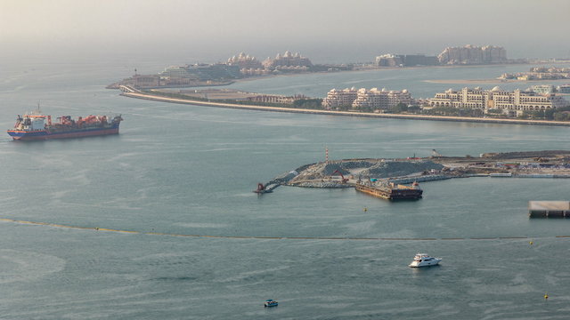 Aerial view of Palm Jumeirah man made island from JBR district before sunset timelapse. Dubai, UAE.