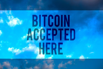 Fototapeta premium Handwriting text Bitcoin Accepted Here. Concept meaning you can purchase things through Cryptocurrencies Multiline text desktop natural blue sky cloudy background send messages