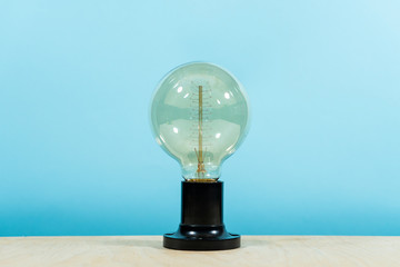 Edison electric lamp, on a blue background. Creative idea.