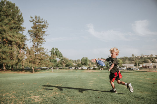 Boy playing flag football, catching a ball, California, United States