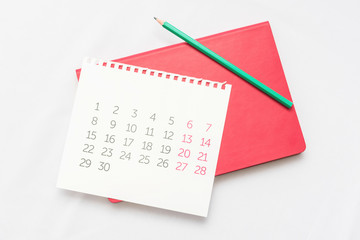 Calendar, pencil and notebook, white desktop, background, copy space, for recording, close up, top view