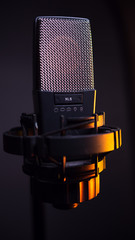 studio condenser microphone, isolated on gradient. with amber light
