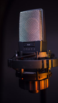 studio condenser microphone, isolated on gradient. with amber light
