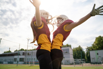 Image of two rugby athletes jumping on playground