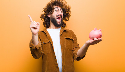 young man with crazy hair in motion and a piggy bank