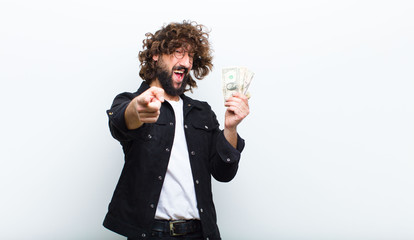 young man with crazy hair in motion and banknotes