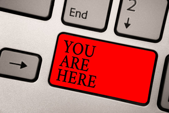 Conceptual hand writing showing You Are Here. Business photo text This is your location reference point global positioning system Greyish silver keyboard with red color button black color texts