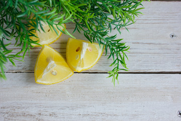 Lemon slices on a white background with a green sprig