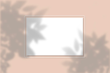 Fototapeta premium Top view of leaf shade on sand color background. Flat style. A piece of paper on a background. Mockup with the imposition of plant shadows. Natural light casts a shadow from above. The scene of an
