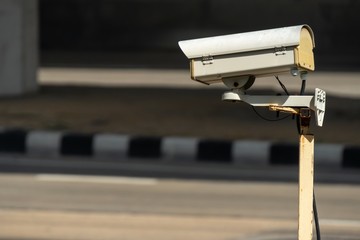 security monitoring CCTV camera mounted on old pole steel post.