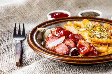 Grilled sausages, French fries and vegetables
