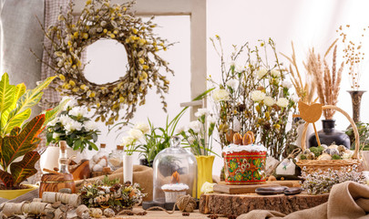 Easter composition with willow and willow lights with Easter eggs and traditional Easter cakes. Holiday concept.