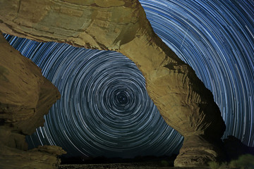 Low angle view of star trails and rock formations, Saudi Arabia