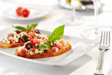 Italian Appetizer Bruschetta with Tomatoes, Cheese and Basil