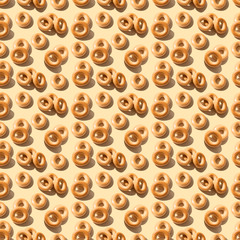 Seamless pattern of many different little bagels on a peach color background . Bakery product template, traditional Russian bread product. Creative layout. Top view