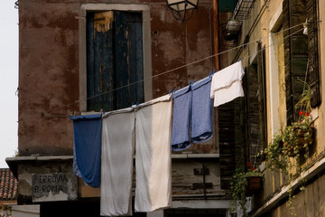 Venice winter mysterious romantic: ropes tied between facades forming clotheslines with clothes hanging