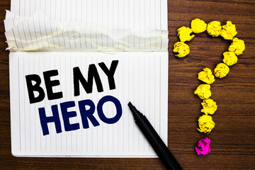 Writing note showing Be My Hero. Business photo showcasing Request by someone to get some efforts of heroic actions for him Notebook marker crumpled paper forming question mark wooden background
