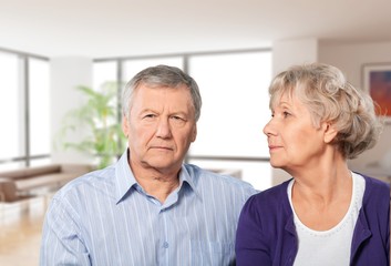 Close-up portrait of an elderly couple hugging in park