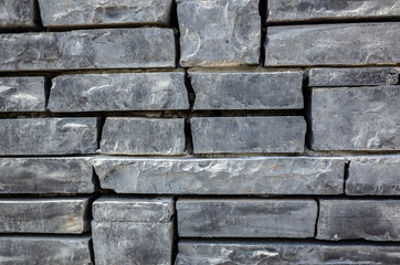 Naklejka premium gray brick wall with rough texture
