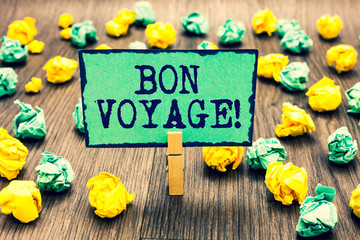 Text sign showing Bon Voyage. Conceptual photo used express good wishes to someone about set off on journey Clothespin holding green note paper crumpled papers several tries mistakes