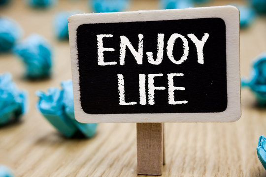 Text sign showing Enjoy Life. Conceptual photo Any thing, place,food or person, that makes you relax and happy Blackboard crumpled papers several tries mistake not satisfied wooden floor