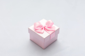Pink square gift box, blue background, copy space, for text, close up