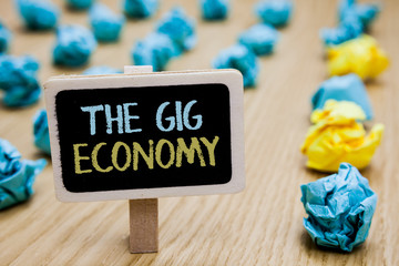 Conceptual hand writing showing The Gig Economy. Business photo text Market of Short-term contracts freelance work temporary poster board with blurry paper lobs laid serially mid yellow lob