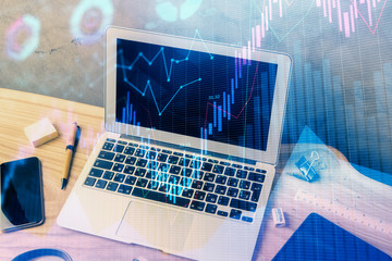 Double exposure of forex graph and work space with computer. Concept of international online trading.