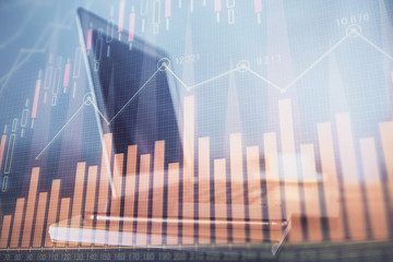 Forex market graph hologram and personal computer on background. Double exposure. Concept of investment.