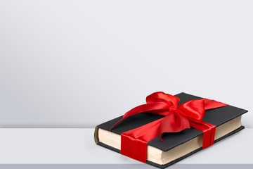 Holy Bible  book in red ribbon on a wooden background