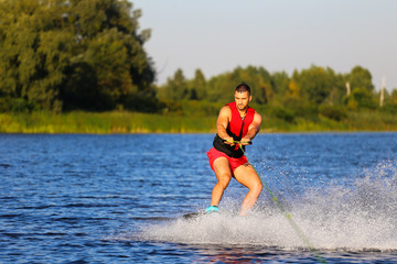 Man making waves on wakeboard 