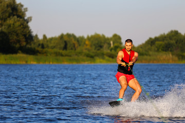 Man making waves on wakeboard 