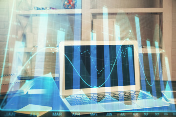 Financial market graph hologram and personal computer on background. Double exposure. Concept of forex.