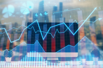Financial graph colorful drawing and table with computer on background. Double exposure. Concept of international markets.