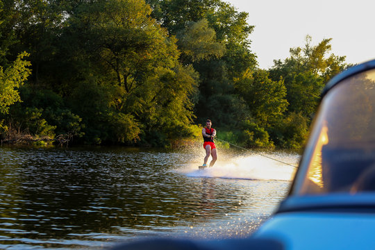 Man making waves on wakeboard 